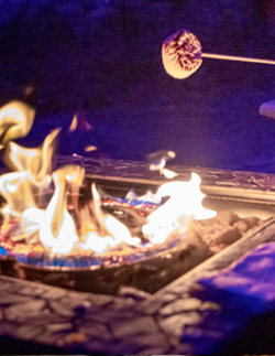 A Tuck-ins inside-out s'more roasting over a fire pit