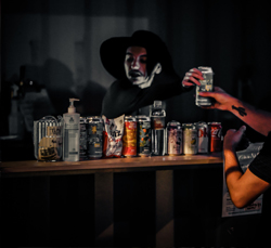 person serving beer to a patron from an outdoor bar at night
