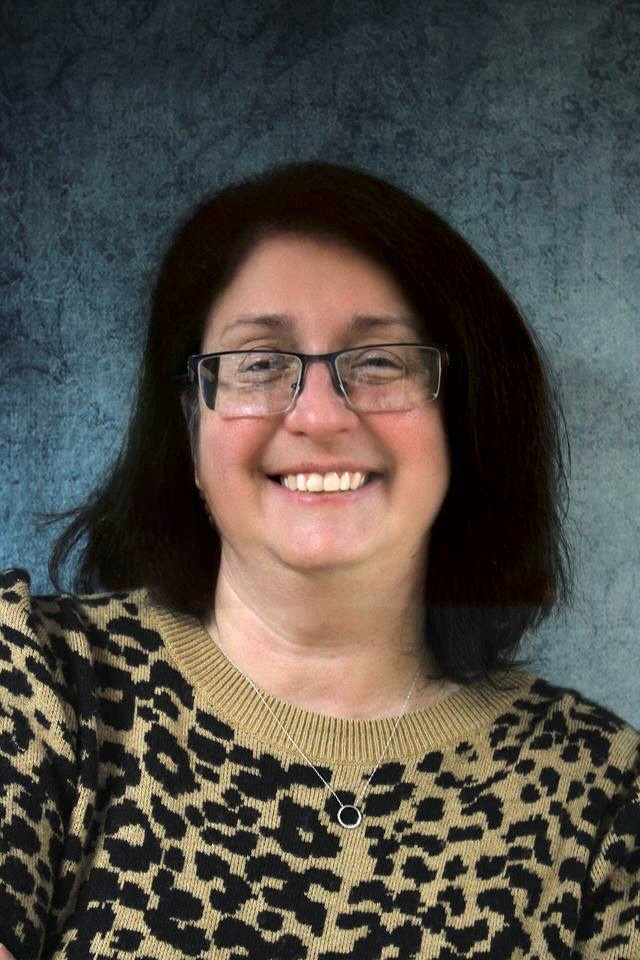 Kim Barben smiles at the camera.