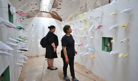 Visitors viewing the artist installation Airplanes